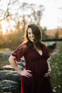 mom to be holds her bump during golden hour maternity session
