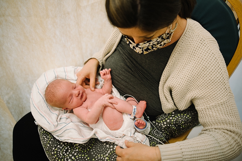 new mom holds baby in Mt Auburn Hospital's NICU