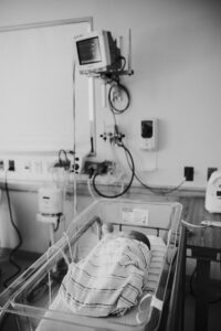 black and white image of baby in Mt Auburn Hospital's NICU