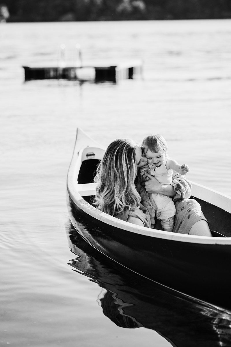 black and white image of mother and infant son in a canoe on Lake Winnipesaukee, New Hampshire