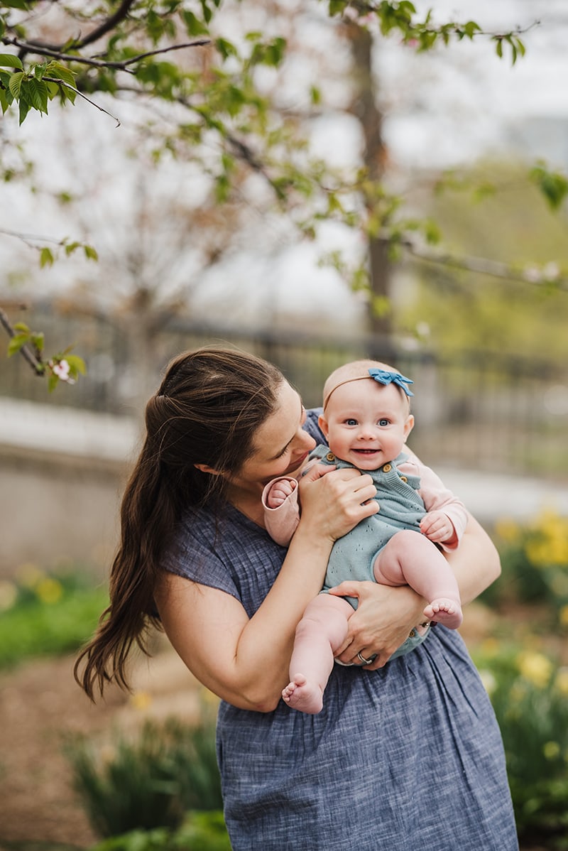mother infant daughter photos with cherry blossoms in the background